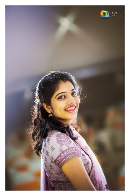 Young woman smiling over her shoulder in soft light