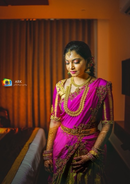 Woman in a pink silk saree in warm evening light