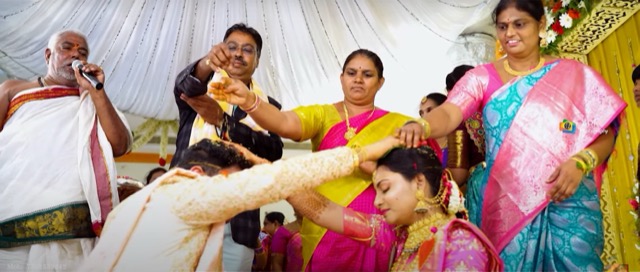 Family members gathered around the couple during a wedding ritual